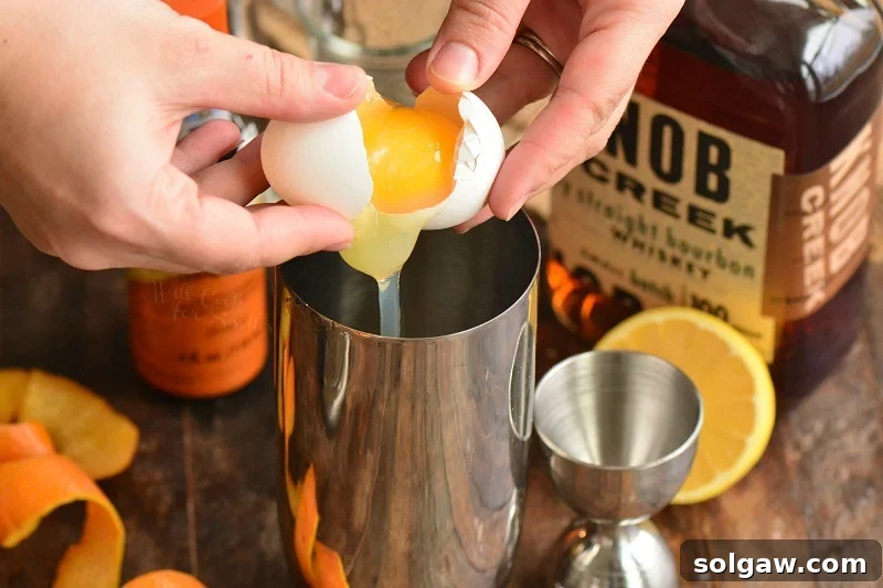 Whiskey Sour Two Takes 7 Adding egg white to the cocktail shaker for a frothy Whiskey Sour.