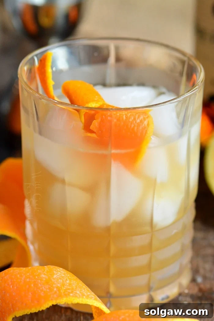 Whiskey Sour Two Takes 10 A Whiskey Sour cocktail without egg white, showing a clear and bright appearance.