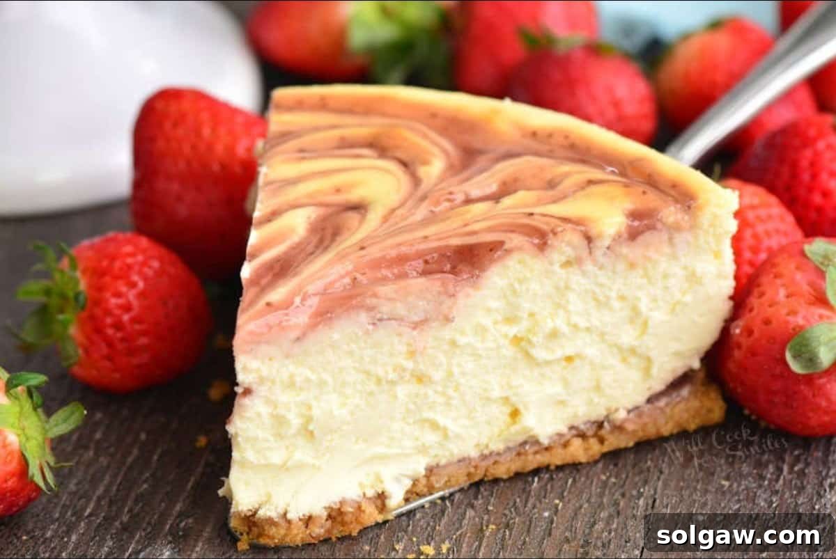 A beautiful slice of strawberry cheesecake, garnished with fresh strawberries, ready to be served.