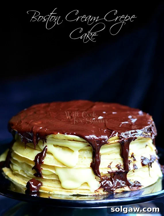 Boston Cream Mille Crepe 3 A beautiful Boston Cream Crepe Cake, whole and uncut, presented elegantly on a shiny metal platter, ready to be served.