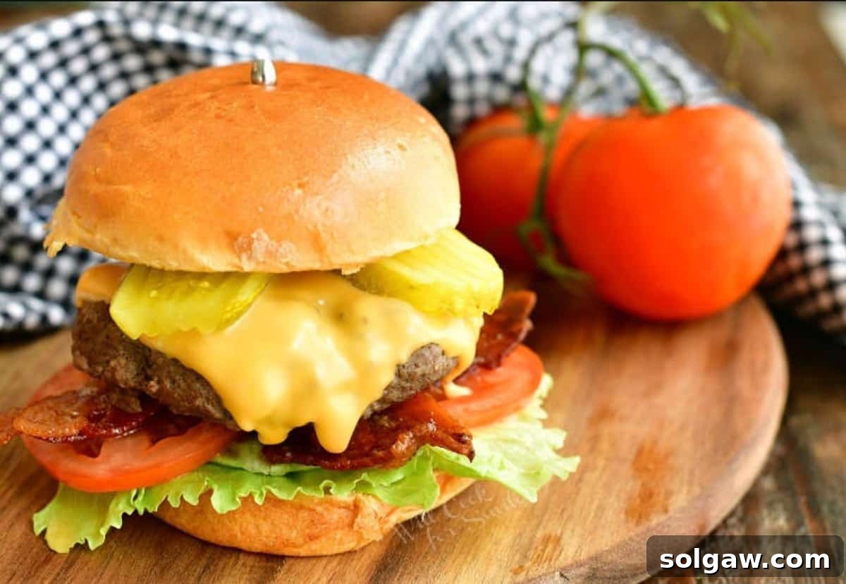 Crafting the Ultimate Burger 7 A delectable cheeseburger on a rustic wooden board, garnished with fresh tomatoes and a checkered towel.