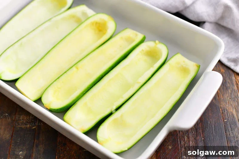 Hearty Italian Beef Stuffed Zucchini 5 hollowed out zucchini halves paid side by side in a baking dish