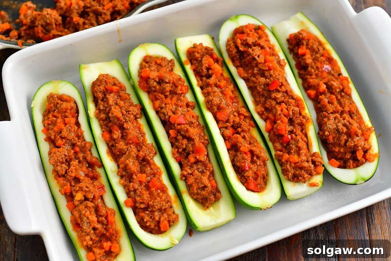 Hearty Italian Beef Stuffed Zucchini 6 zucchini halves paid side by side in a baking dish and filled with tomato beef mixture