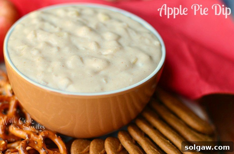 Close-up of Homemade Apple Pie Dip in a vibrant orange bowl, showcasing its creamy texture and chunks of spiced apple