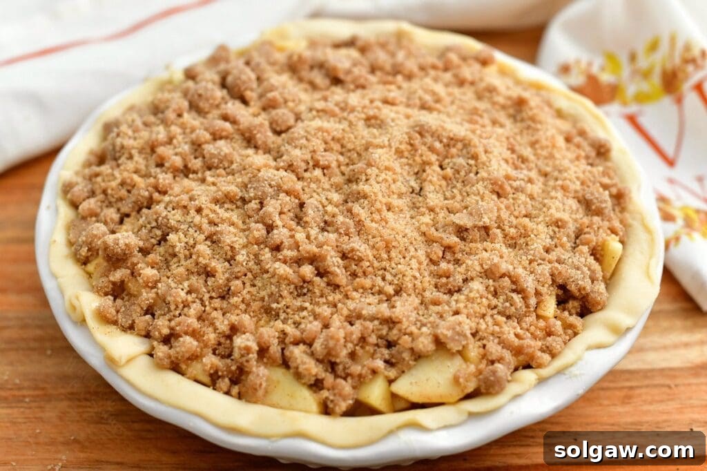 Apple pie with crumble topping, ready for baking