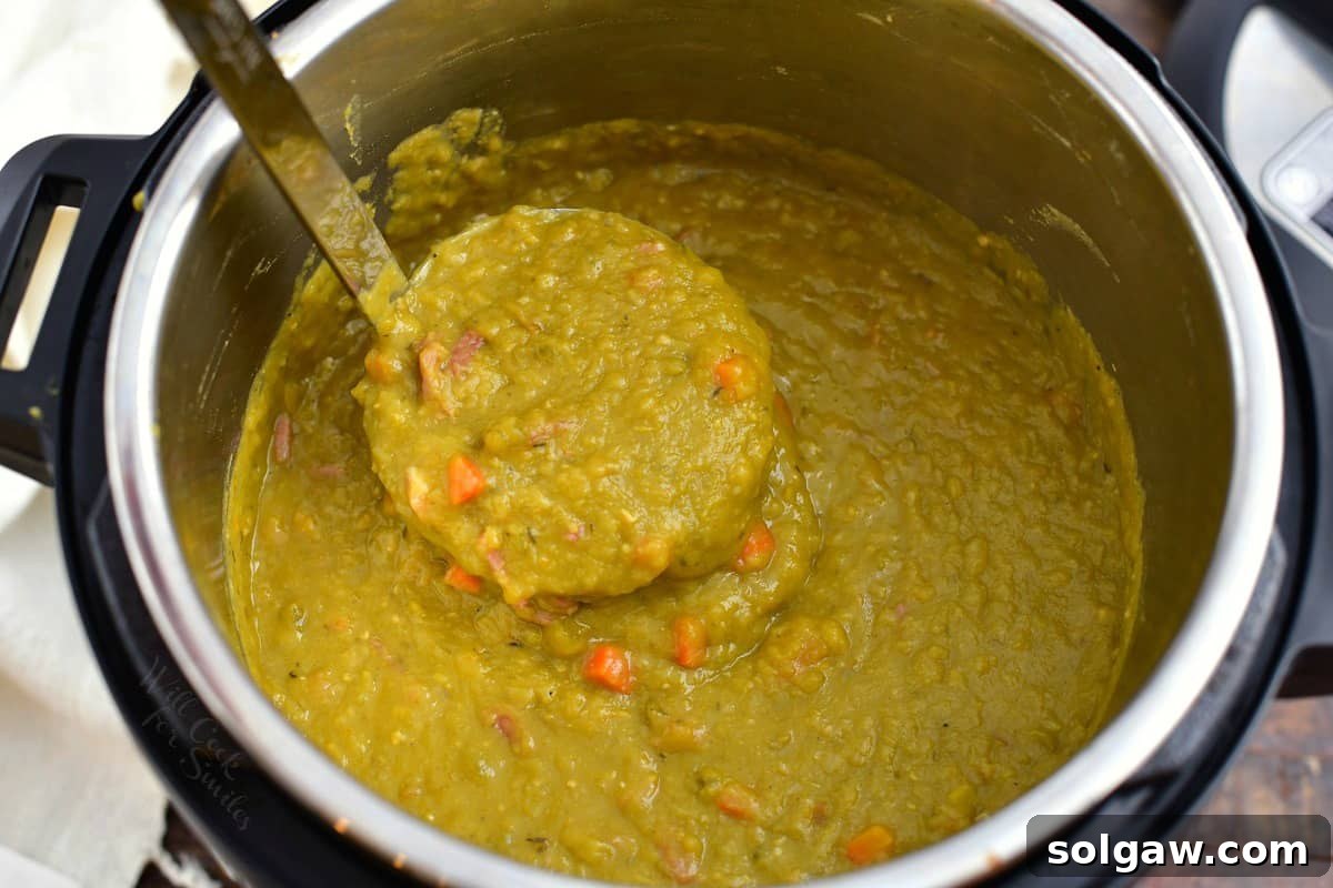 pulling out a ladle full of thick pea soup in an Instant Pot.