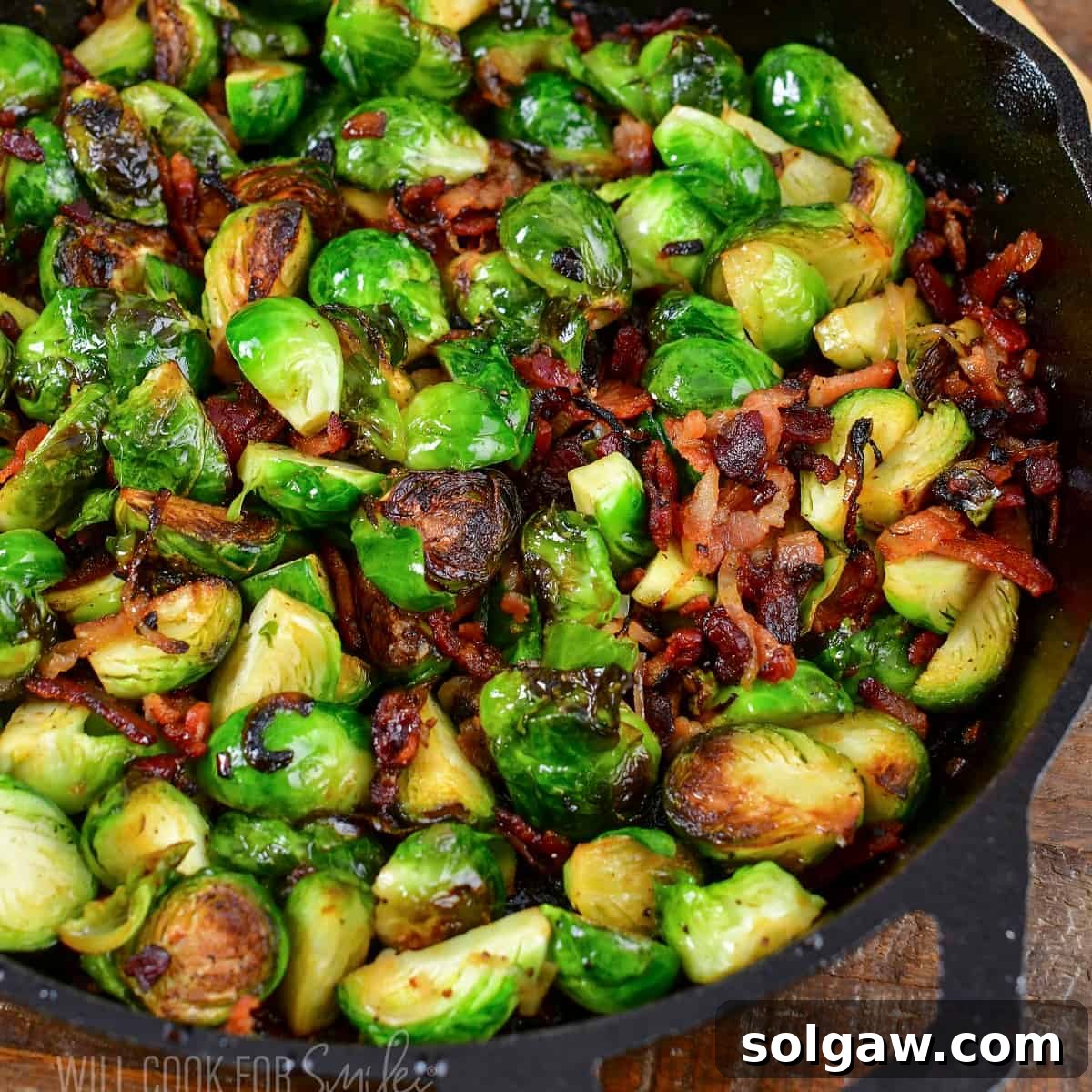 Squared image closeup roasted brussels sprouts in a skillet.