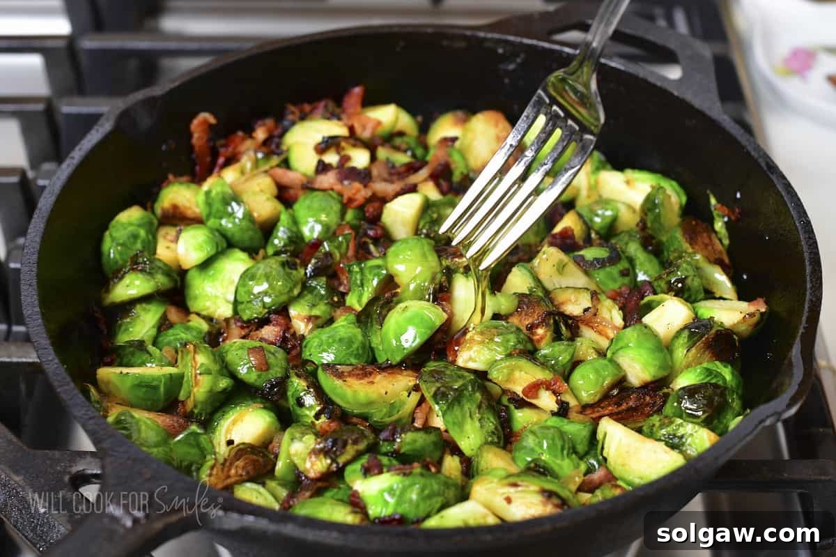 Drizzling honey over the hot Brussels sprouts and bacon during the final cooking stage.