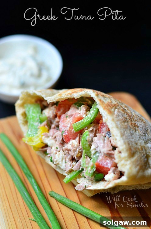 Coastal Tuna Pita with Bright Herb Aioli 2 Delicious Greek Tuna Pita on a rustic cutting board, ready to be enjoyed