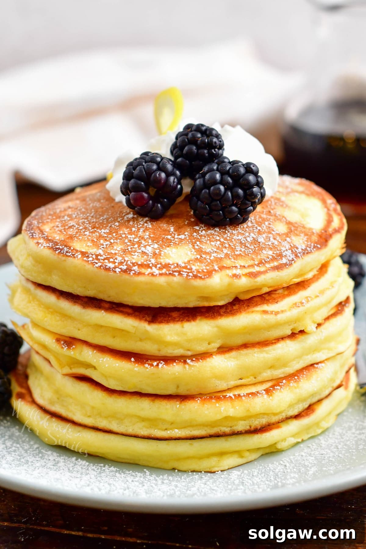 A stack of ricotta pancakes is ready to be eaten.