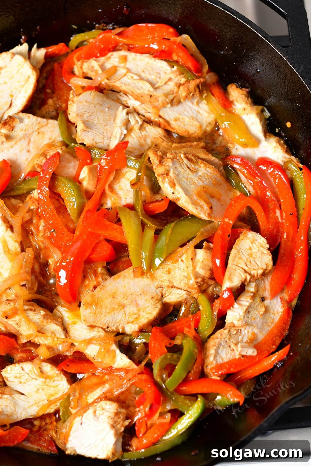 Chicken and vibrant veggies mixed in a skillet, ready to serve.