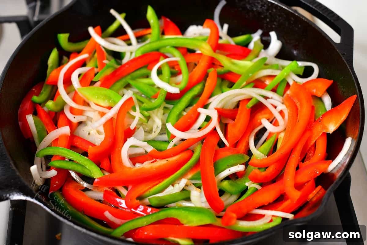 Sizzling Chicken Fajitas 5 Freshly sliced bell peppers and onions awaiting cooking in a large skillet.