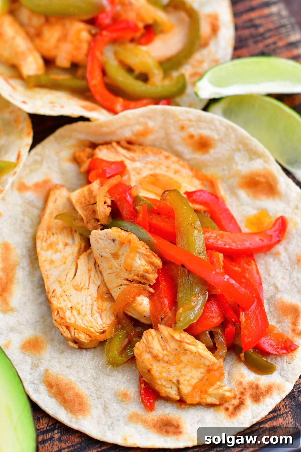 Sizzling Chicken Fajitas 9 Delicious chicken fajitas assembled in warm flour tortillas, garnished and ready to eat.