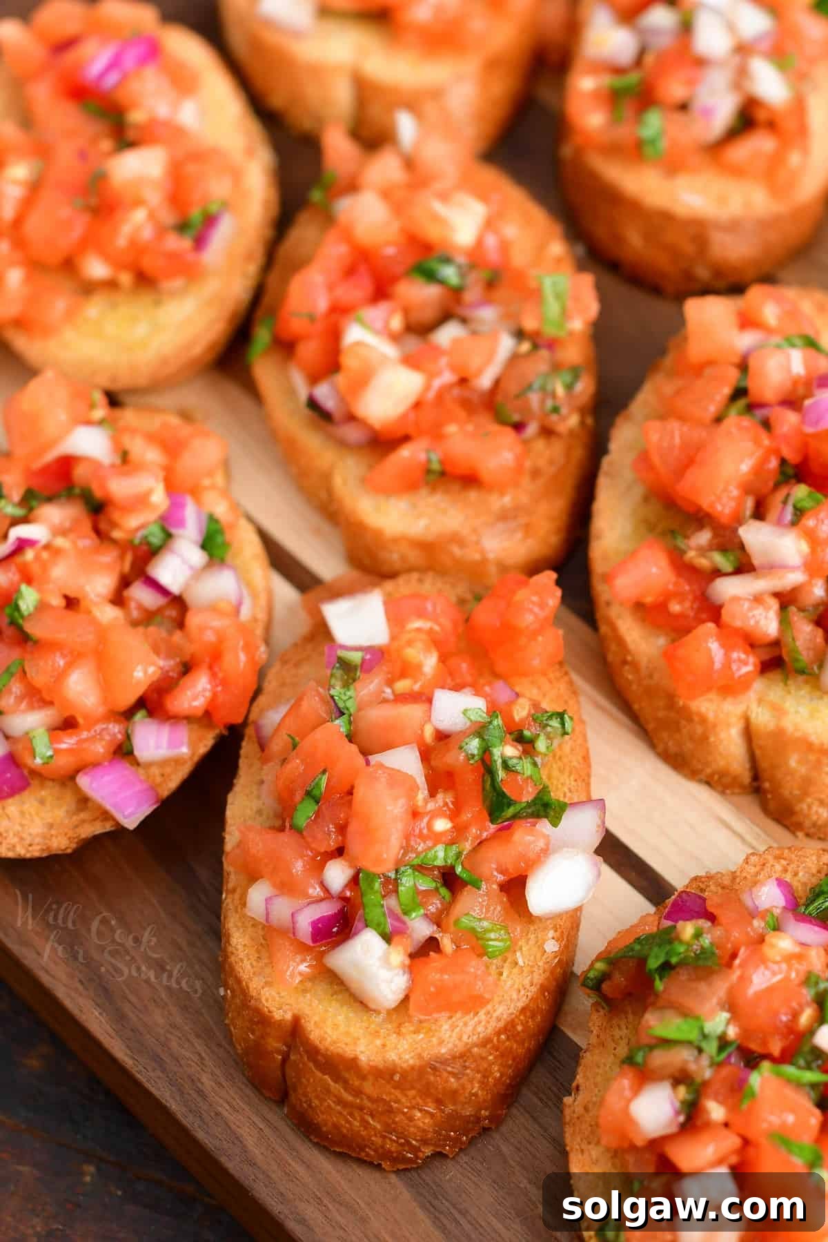 Beautifully presented bruschetta with fresh toppings on a platter.