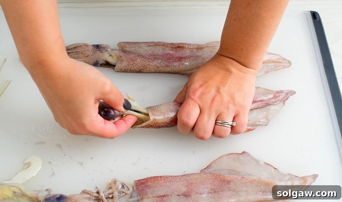 pulling off the head and tentacles off the squid body