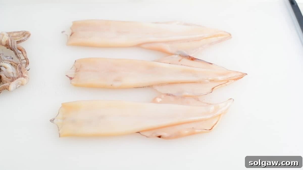 three squid mantle cleaned out with fins attached