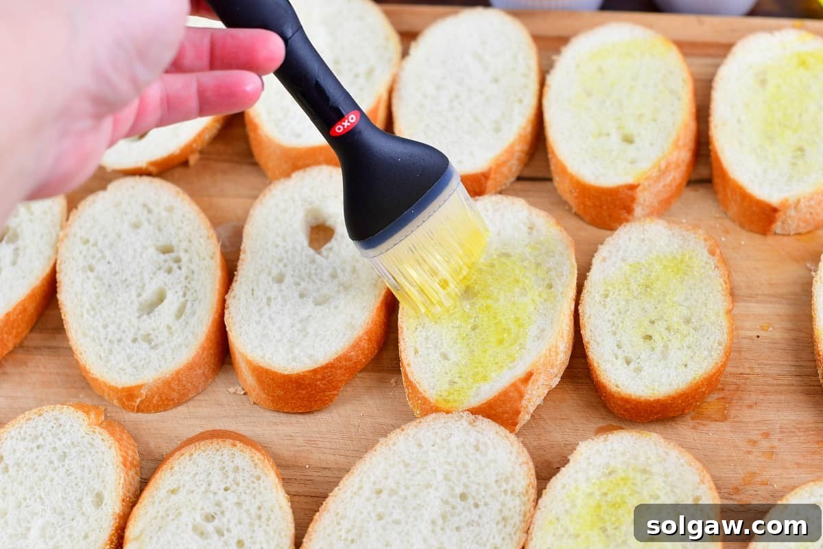 brushing slices of baguette with olive oil