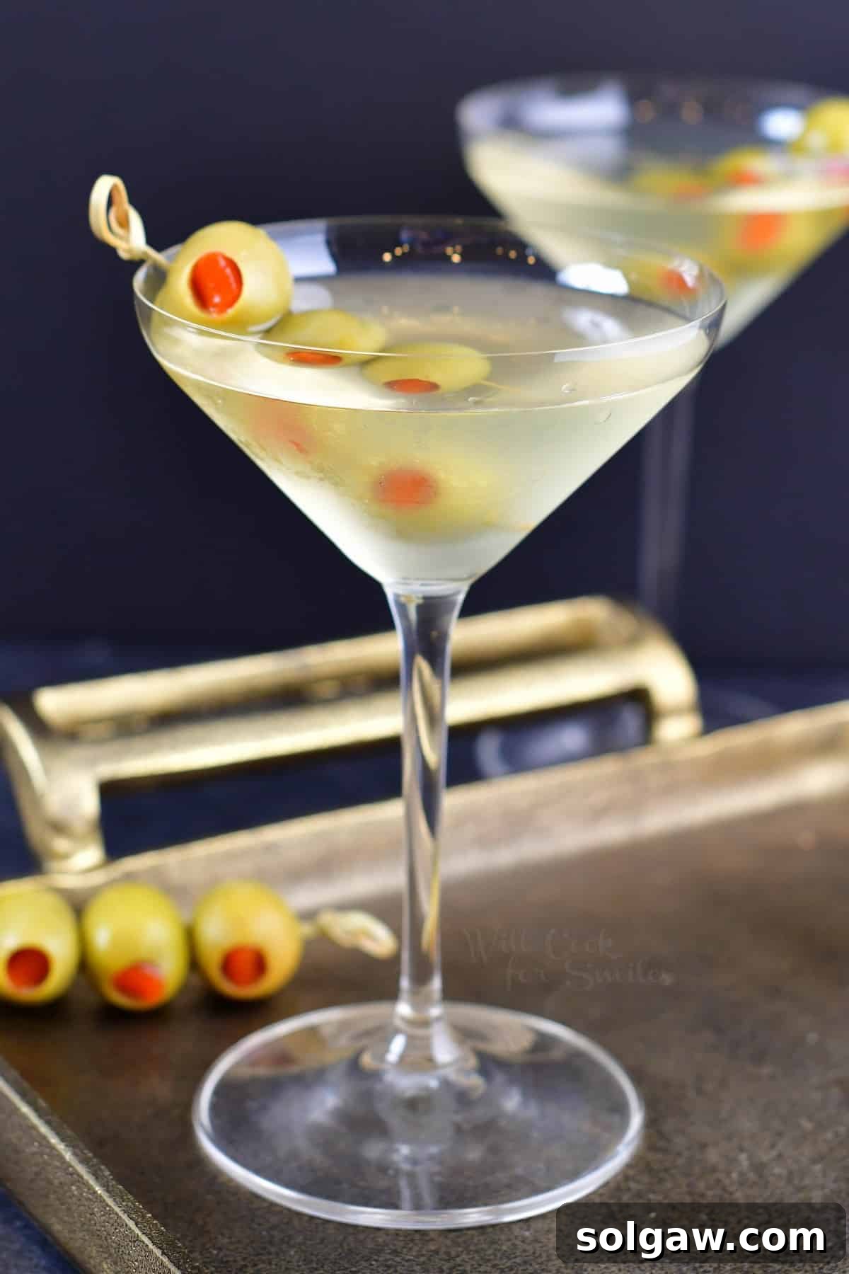 The Maverick's Martini 2 side view of the martini in a tall glass with olives