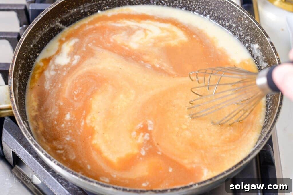 Homemade Poutine Perfection 11 stirring in beef stock into the roux