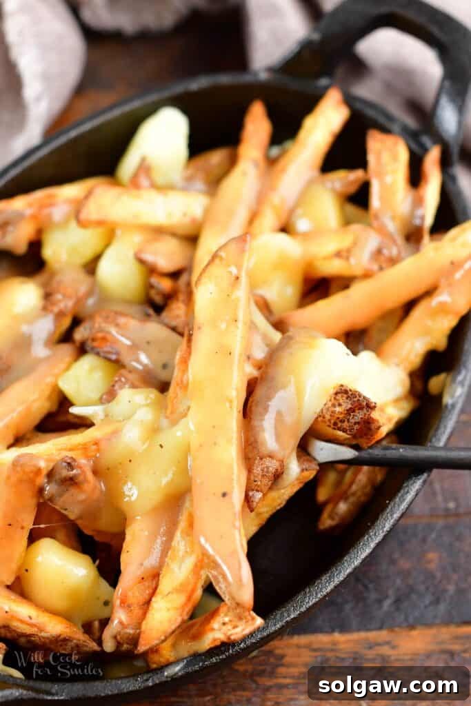 Homemade Poutine Perfection 14 scooping out some gravy covered fried with fork