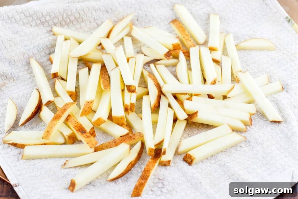 Homemade Poutine Perfection 7 cut potatoes on a towel after soaking