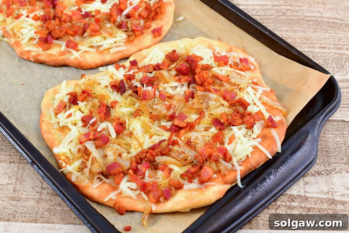 Sweet Golden Onion Smoky Bacon Gruyere Flatbread 12 flatbread crust topped with a generous layer of melted cheese, crispy bacon, and golden caramelized onion