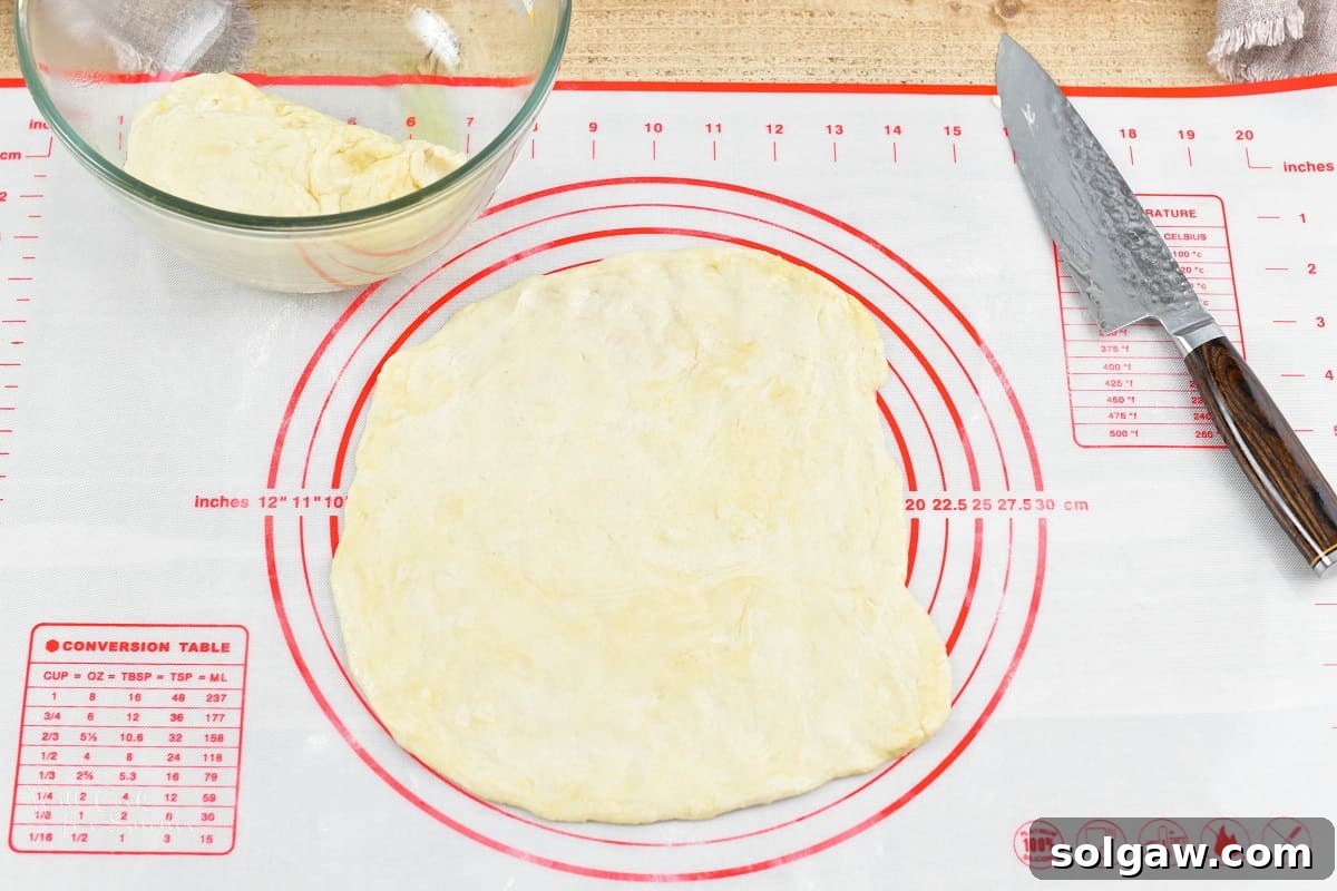 Sweet Golden Onion Smoky Bacon Gruyere Flatbread 9 rolled out flatbread crust on the silicone mat, thin and ready for transfer to the baking sheet