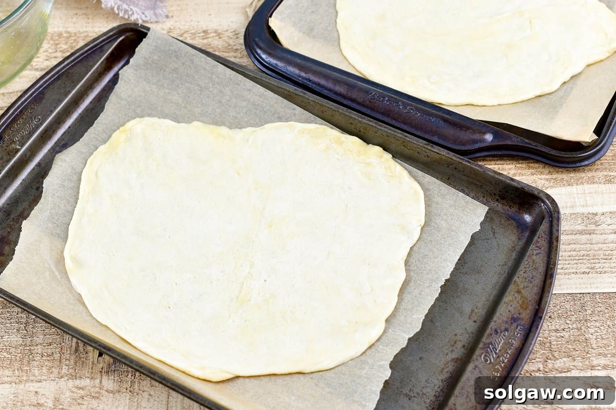 Sweet Golden Onion Smoky Bacon Gruyere Flatbread 10 flatbread crust dough carefully placed on the baking sheet, prepared for the initial bake