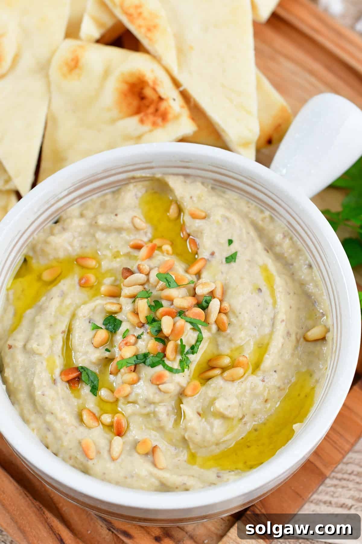 Smoky Aubergine Mezze 11 Top view of Baba Ganoush in a bowl, garnished with pine nuts, olive oil, and parsley