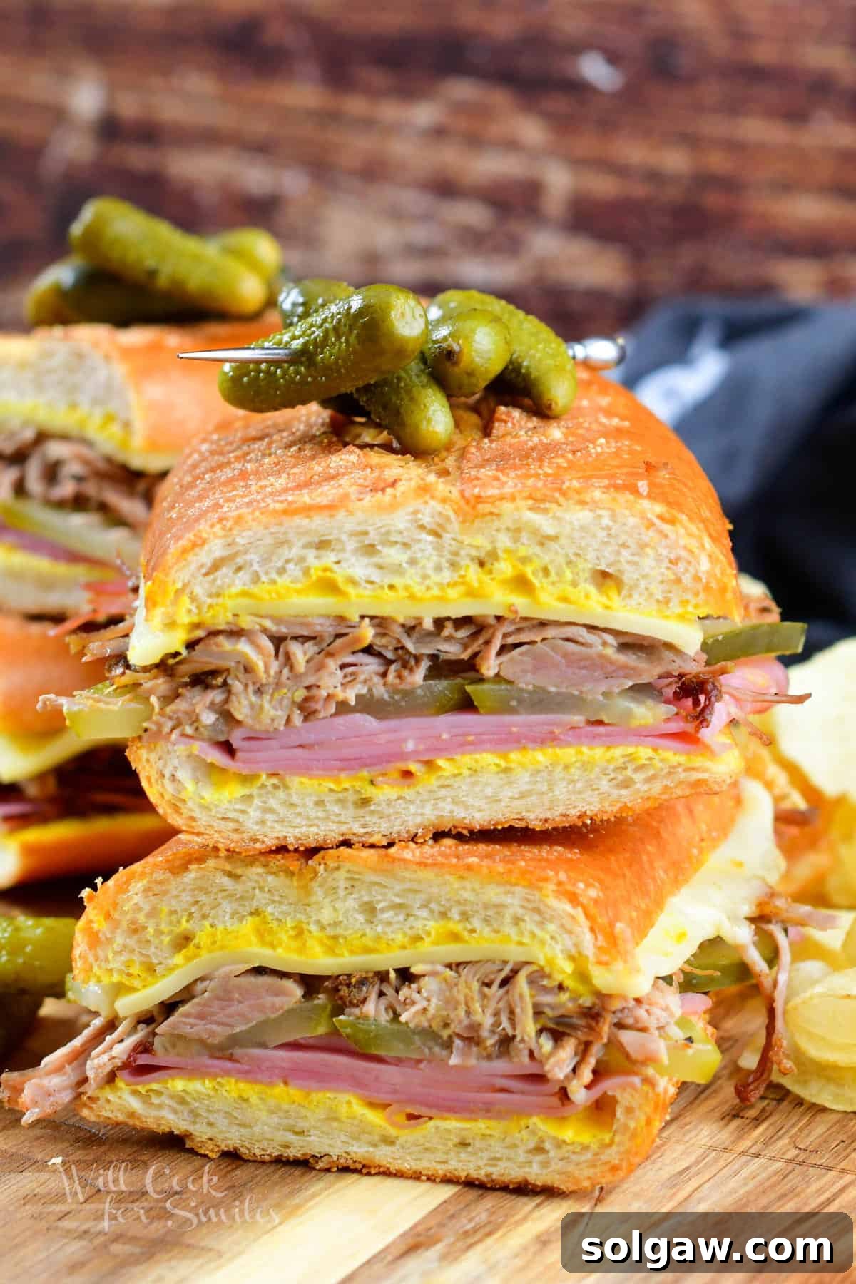 front view of the Cuban sandwich halves stacked with pickles on top