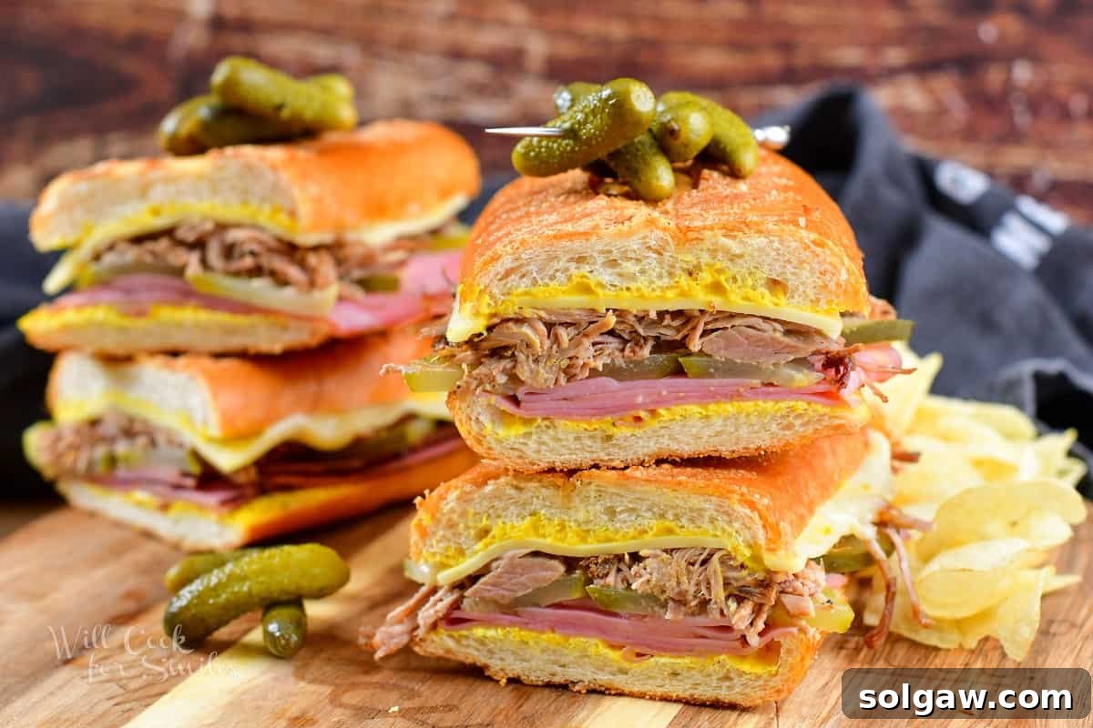 closeup of two Cuban sandwich halves stacked, with more in the background