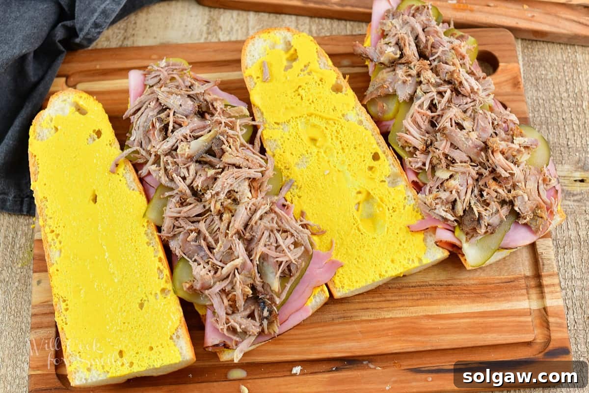 four slices of bread and two topped with pork for Cuban sandwiches