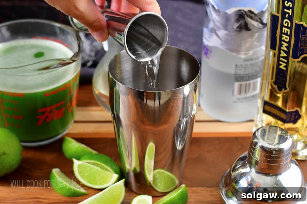 Adding vodka to a cocktail shaker.