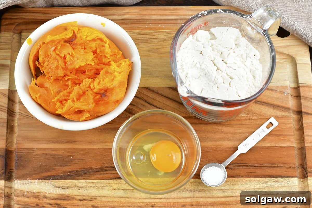 Ingredients for making sweet potato gnocchi laid out on a wooden board: sweet potatoes, flour, and an egg.