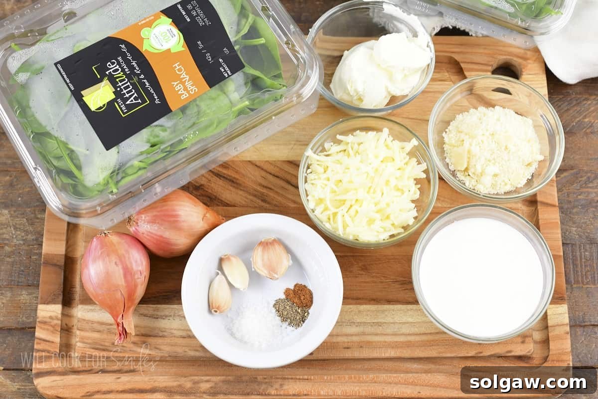 Decadent Cheesy Creamed Spinach 3 Ingredients laid out on a wooden cutting board, ready to make creamed spinach.