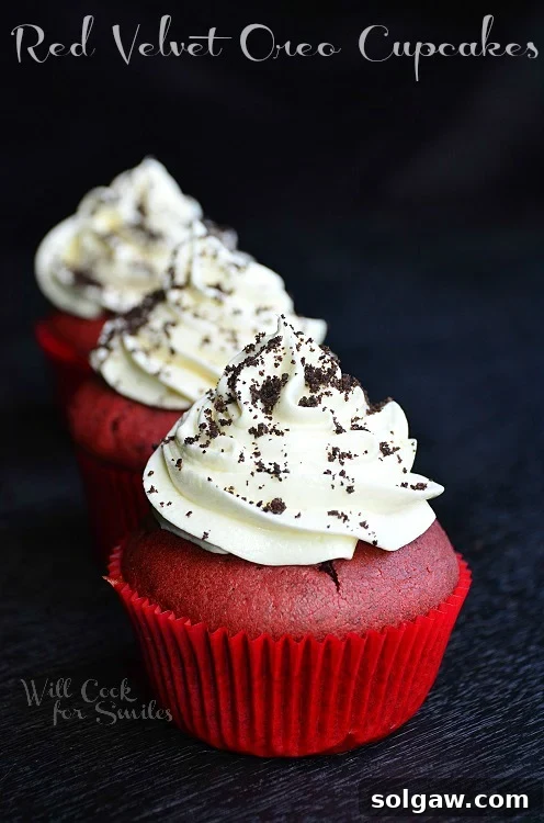 Close-up of Red Velvet Oreo Cupcakes with white frosting and crushed Oreos on top, beautifully arranged.