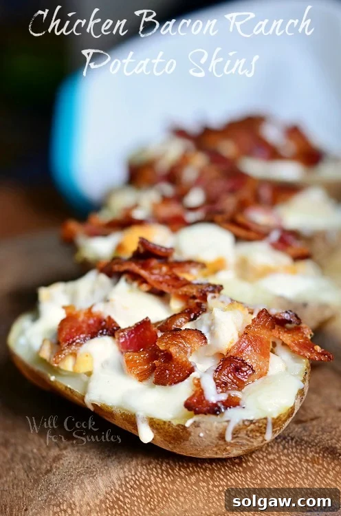 Ultimate Chicken Bacon Ranch Potato Skins 4 Close-up of four Chicken Bacon Ranch Loaded Potato Skins arranged perfectly on a wooden board, ready for serving