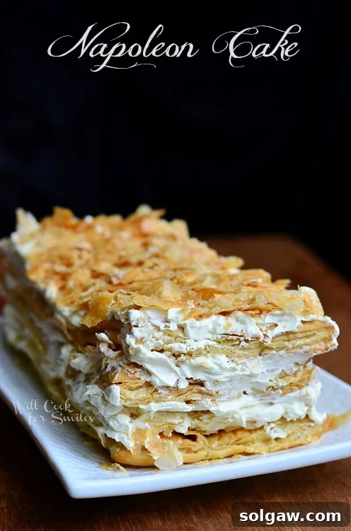 Classic Napoleon Cake 2 Napoleon Cake, a classic Russian puff pastry dessert, beautifully arranged on a white plate ready to be served.