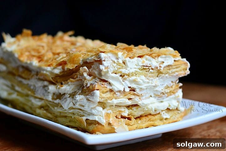 A beautifully layered Napoleon Cake, topped with crumbs, ready to be enjoyed.
