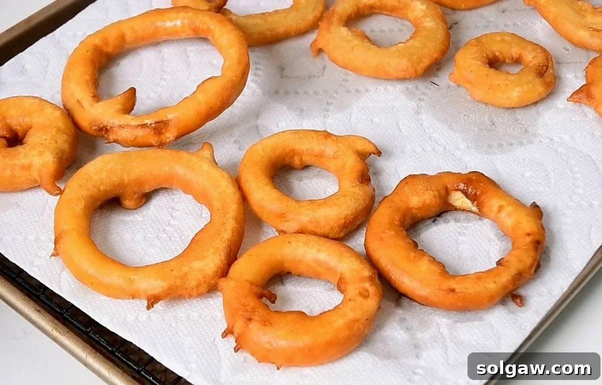 fried beer batter onion rings on a paper towel