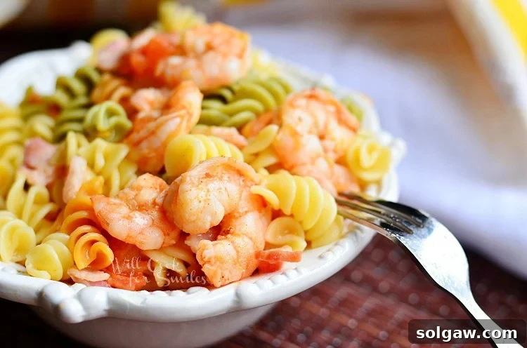 An overhead view of the vibrant Chipotle Shrimp Bacon & Tomato Pasta Bowl, showcasing the colorful ingredients.