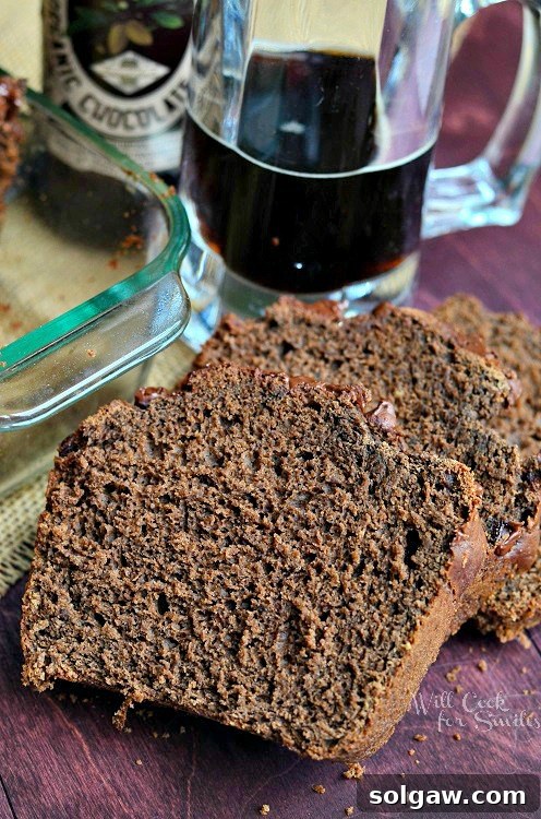 Close up of several slices of Chocolate Stout Bread on a wooden board