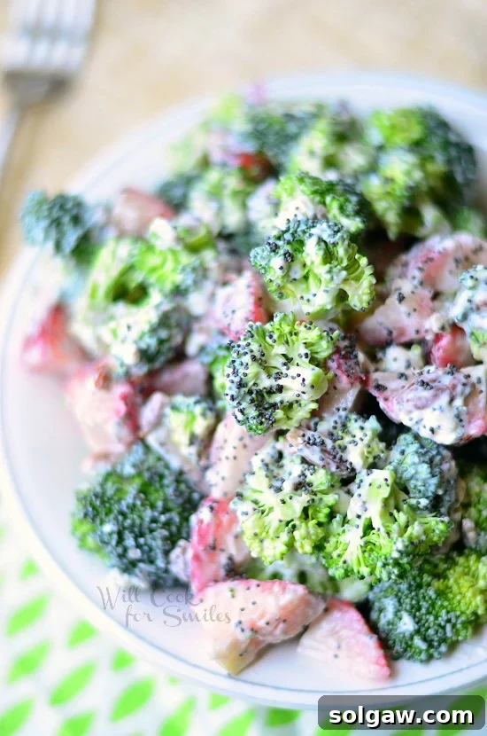 Close-up overhead view of the Strawberry Broccoli Salad in a bowl, showing the mix of ingredients and dressing.