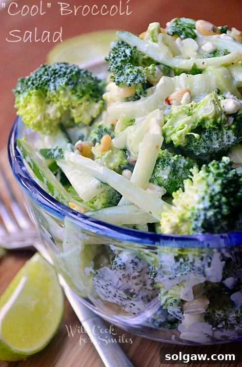 A refreshing Cucumber Broccoli Salad served in a clear glass bowl, showcasing fresh green vegetables.