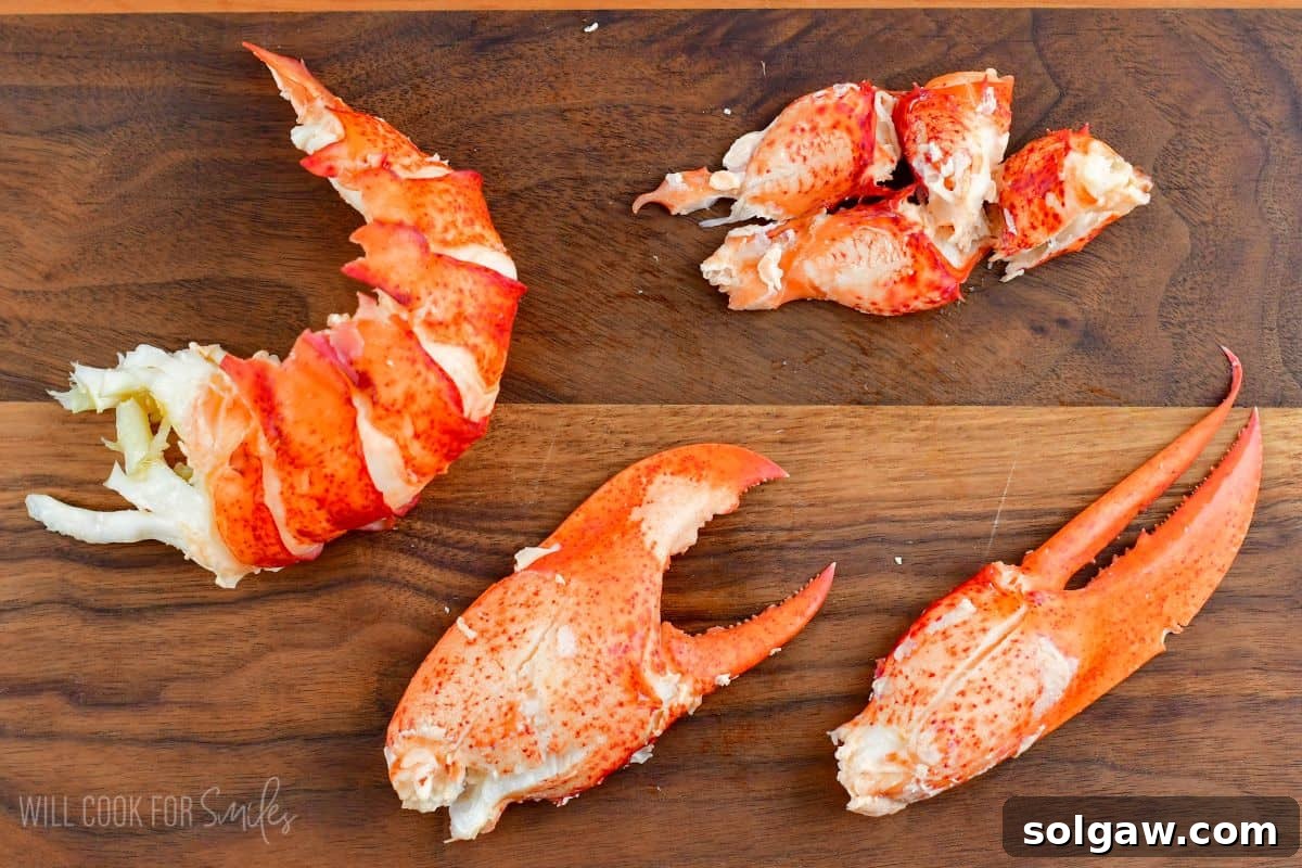 Unlock the Flavor: Perfect Lobster Every Time 8 Succulent lobster meat, carefully extracted from the tail and claws, arranged neatly on a wooden cutting board.