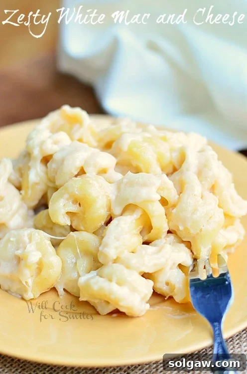 Zesty White Mac & Cheese on a yellow plate with a fork