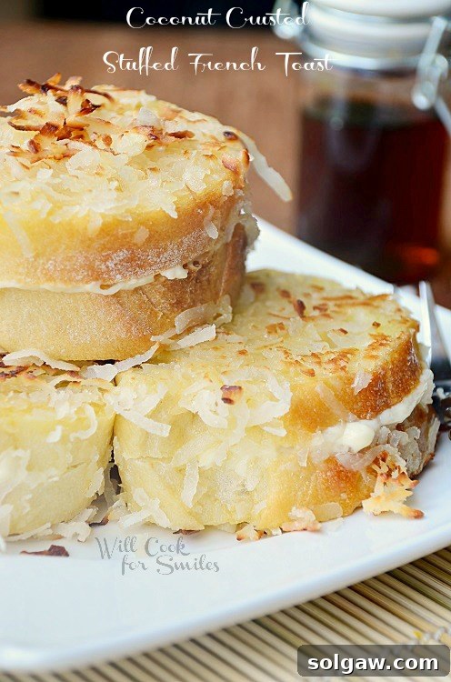 Spiced Apple Pie French Toast 13 Coconut Stuffed French Toast stacked on a white plate with coconut flakes