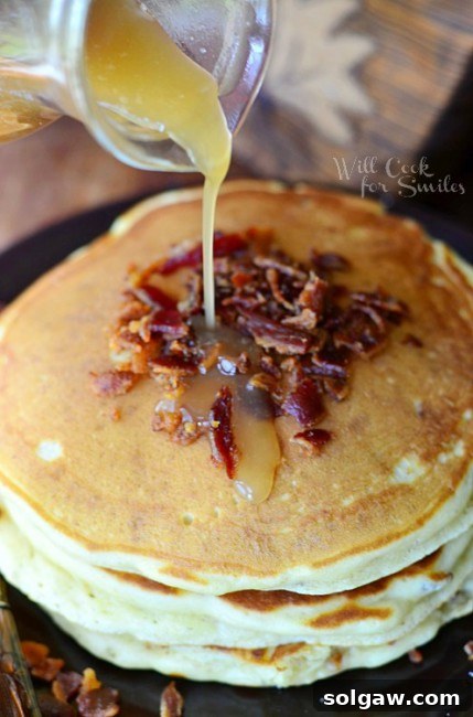 Spiced Apple Pie French Toast 15 Maple Bacon Pancakes stacked on a plate with syrup being poured over them