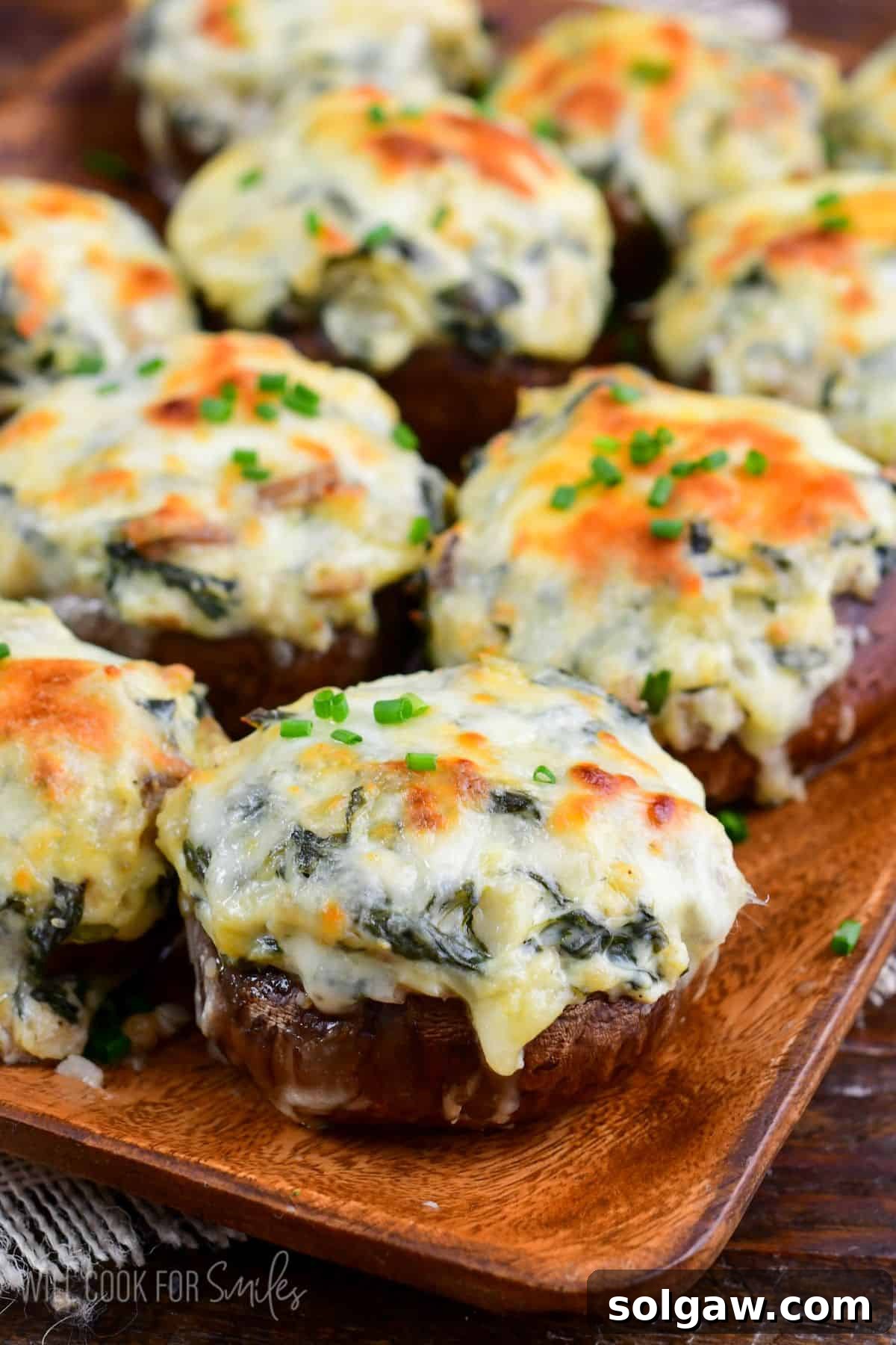 Creamy Spinach Artichoke Stuffed Mushrooms 6 several spinach artichoke stuffed mushrooms with golden melted mozzarella cheese on top.