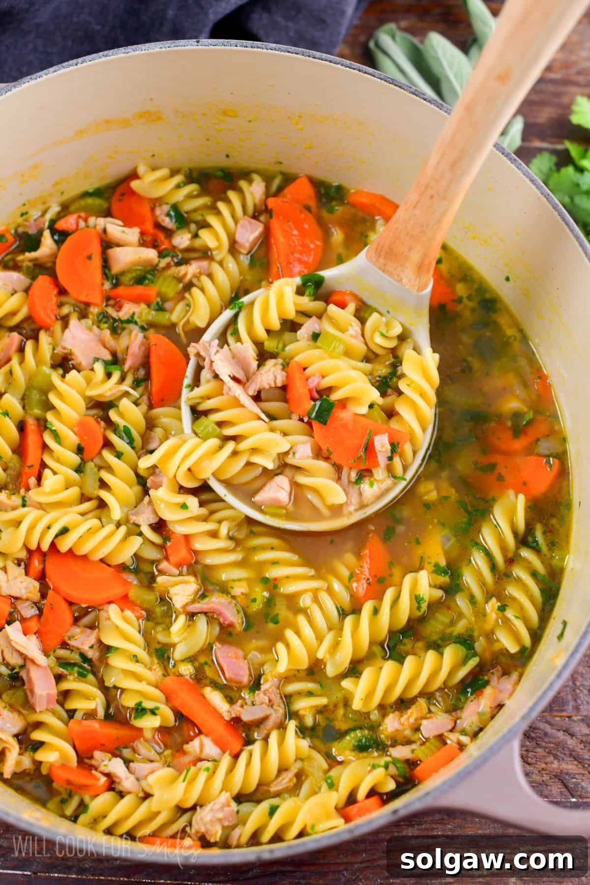Hearty turkey noodle soup featuring leftover turkey, sautéed vegetables, fresh herbs, and soft noodles in a rich broth.